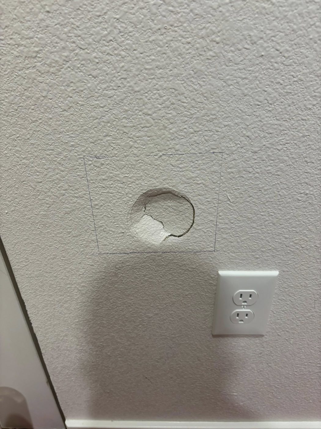 Drywall hole before patch